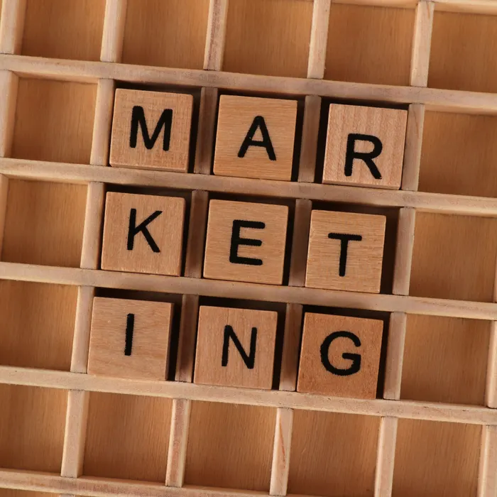 Wooden tiles arranged in a row spelling the word Marketing